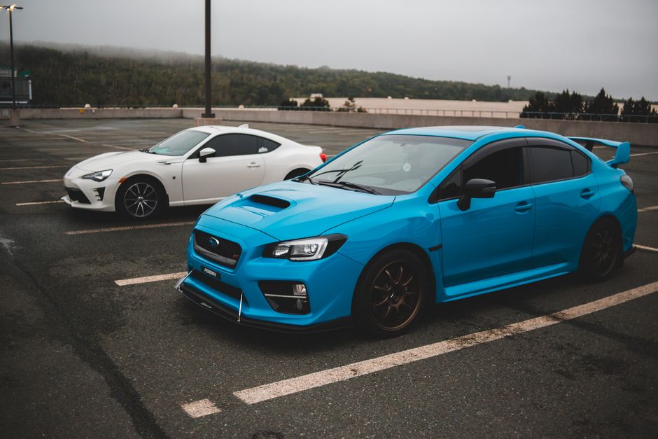 Modern fast clean automobiles parked on concrete surface